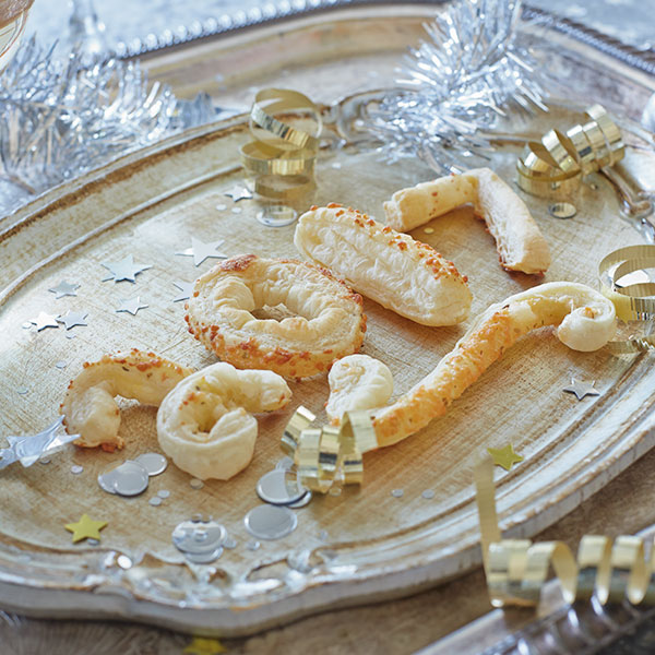 Light and crispy cheese straws arranged on a platter.