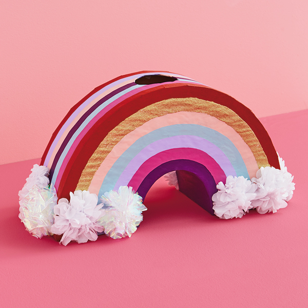 A valentine box shaped like a rainbow with clouds at the end.
